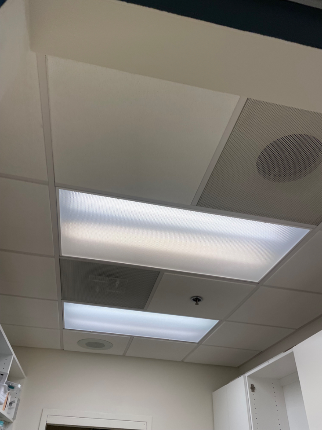 A room with a ceiling that has a light on it