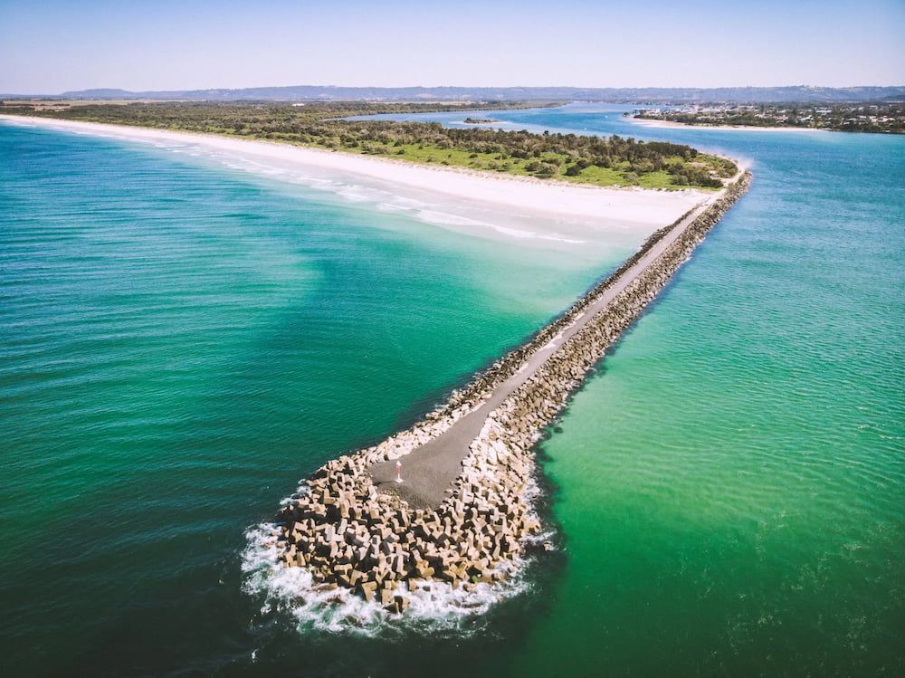 A Long Stone Breakwater Extends Into Turquoise Water — Superior Wifi in Ballina, NSW