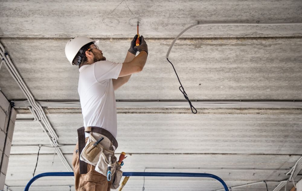 Electrician installer with a Tool in his Hands — Electrician Near Me in NSW