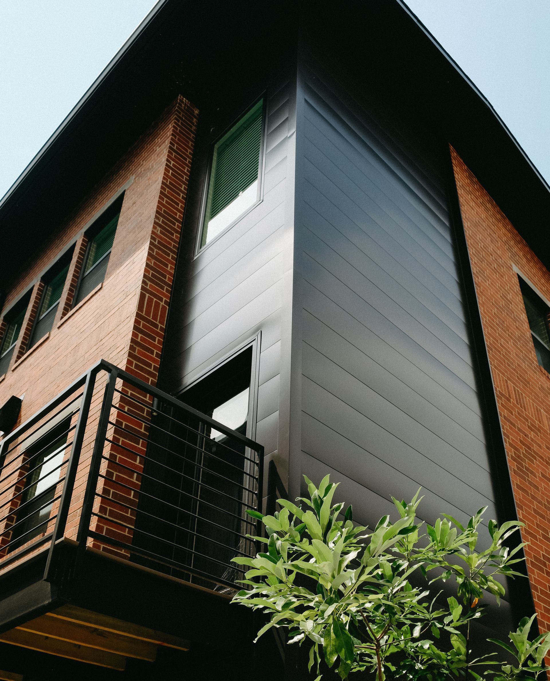 A drainage system is being installed on the side of a building.