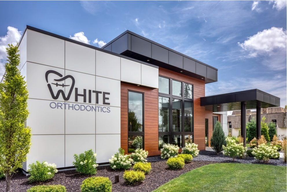 Modern dental office exterior: white and wood paneling,