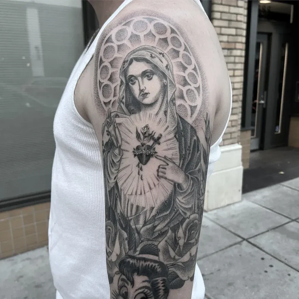 A man has a tattoo on his arm of a woman holding a heart