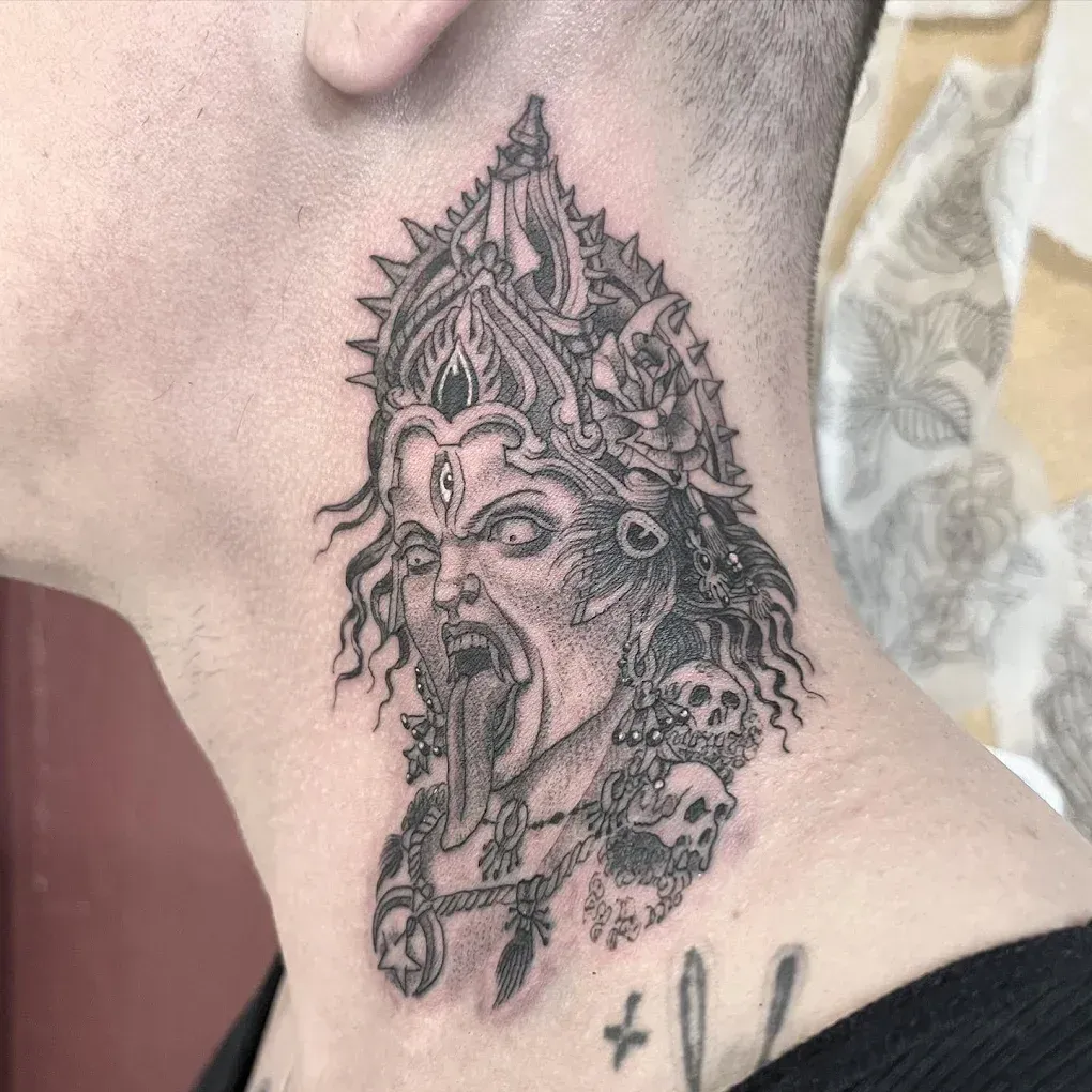 A woman has a tattoo of a woman with a crown on her head