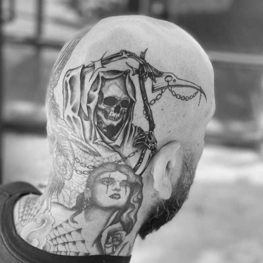 A man has a grim reaper tattoo on his head and neck