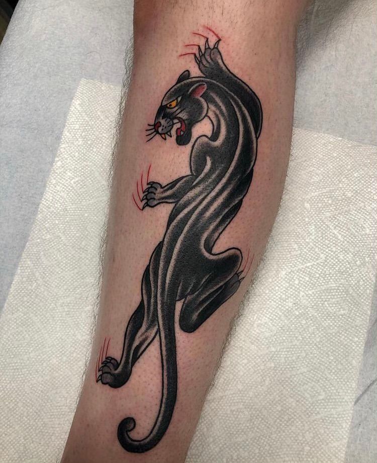A black panther tattoo on a person 's leg.