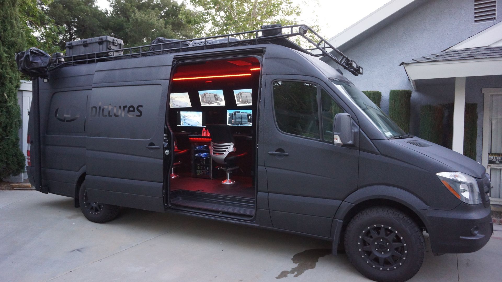 Mobile command center interior with work areas and multiple monitors.