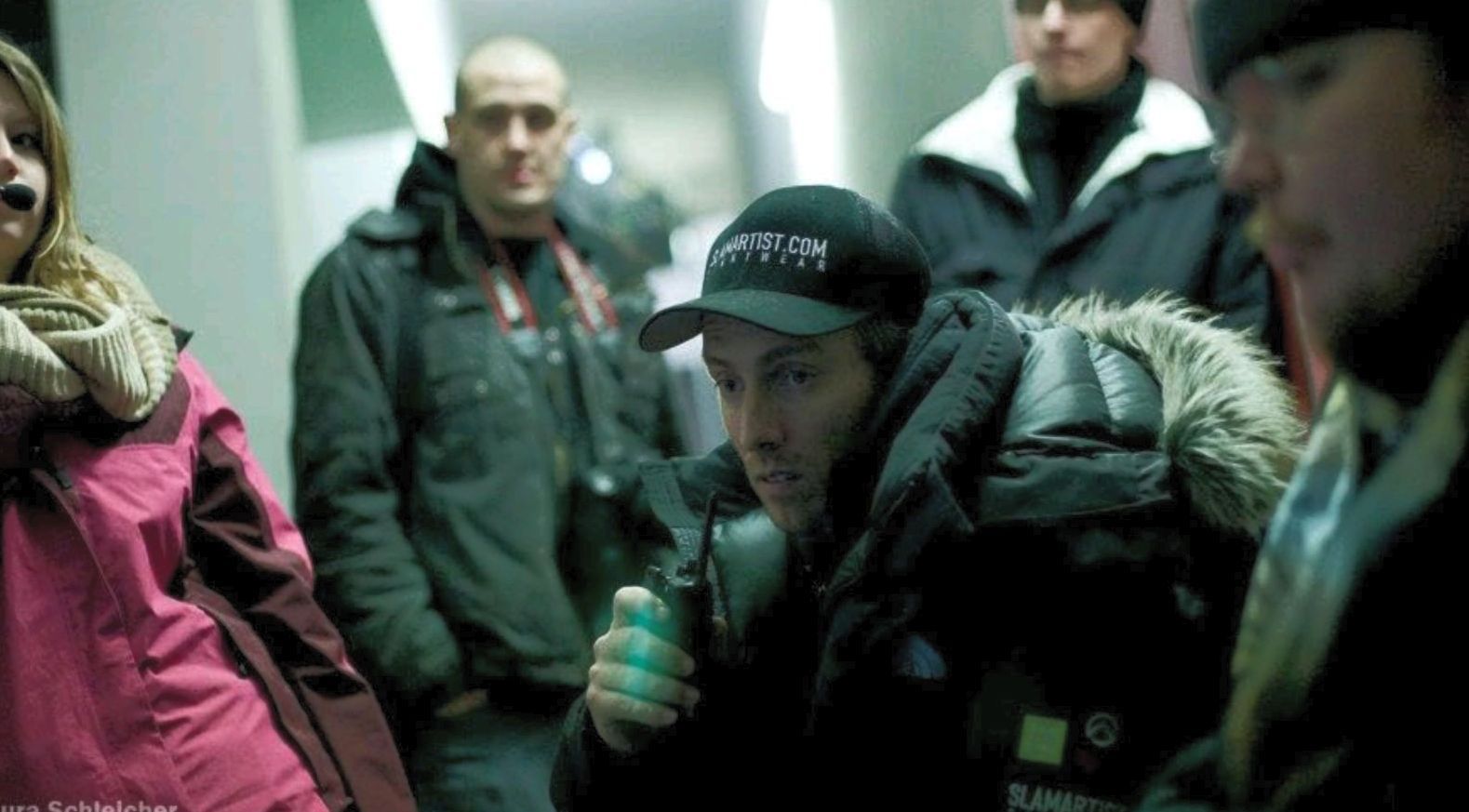 Ferdi, with a radio in hand, intently watches the action unfolding on the monitor