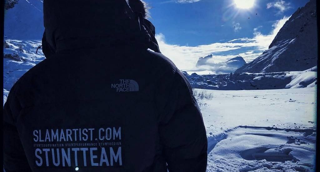Stunt coordinator Ferdi Fischer standing on top of a snowy mountain