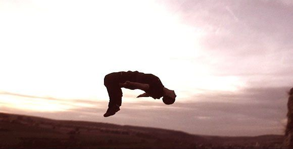 side and wide mid‑air shot of stuntman Ferdi Fischer during the world record 45 m fall into boxes