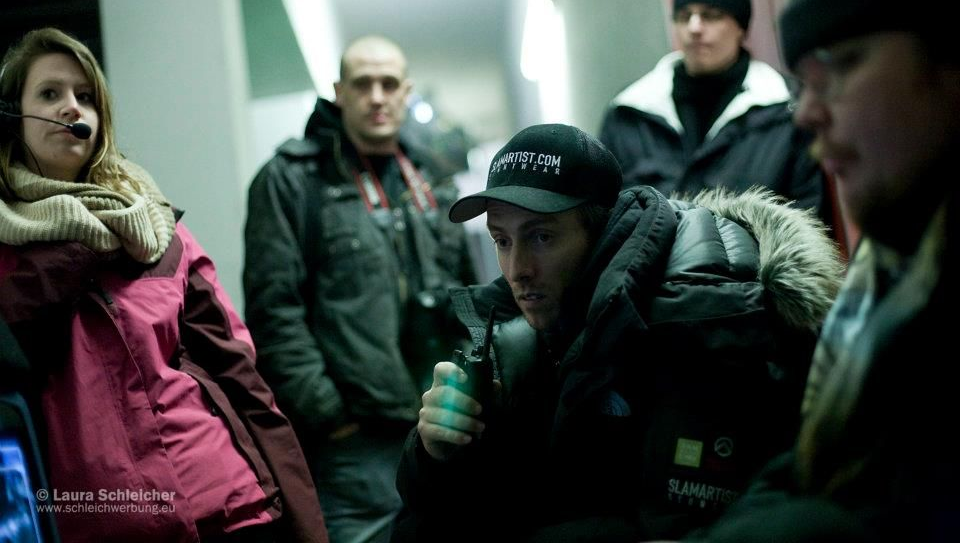 Ferdi Fischer reviewing a fight scene at Video Village on a German film set.