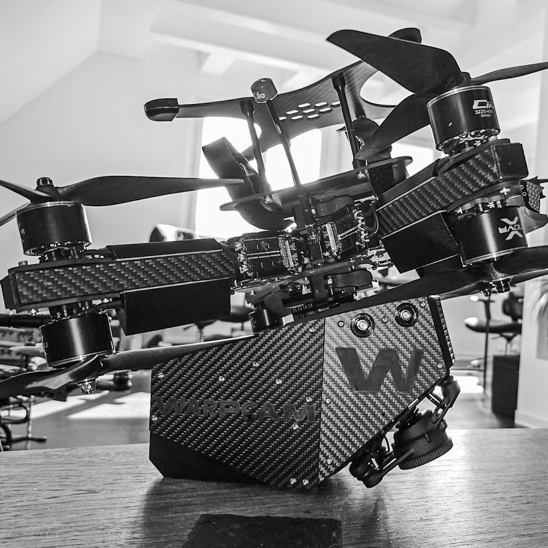 WarpCam® camera rig mounted on a carbon-fiber FPV drone.