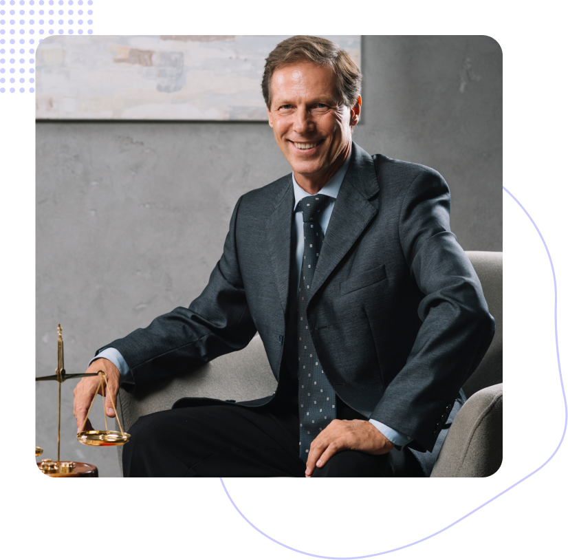A man in a suit and tie is sitting in a chair