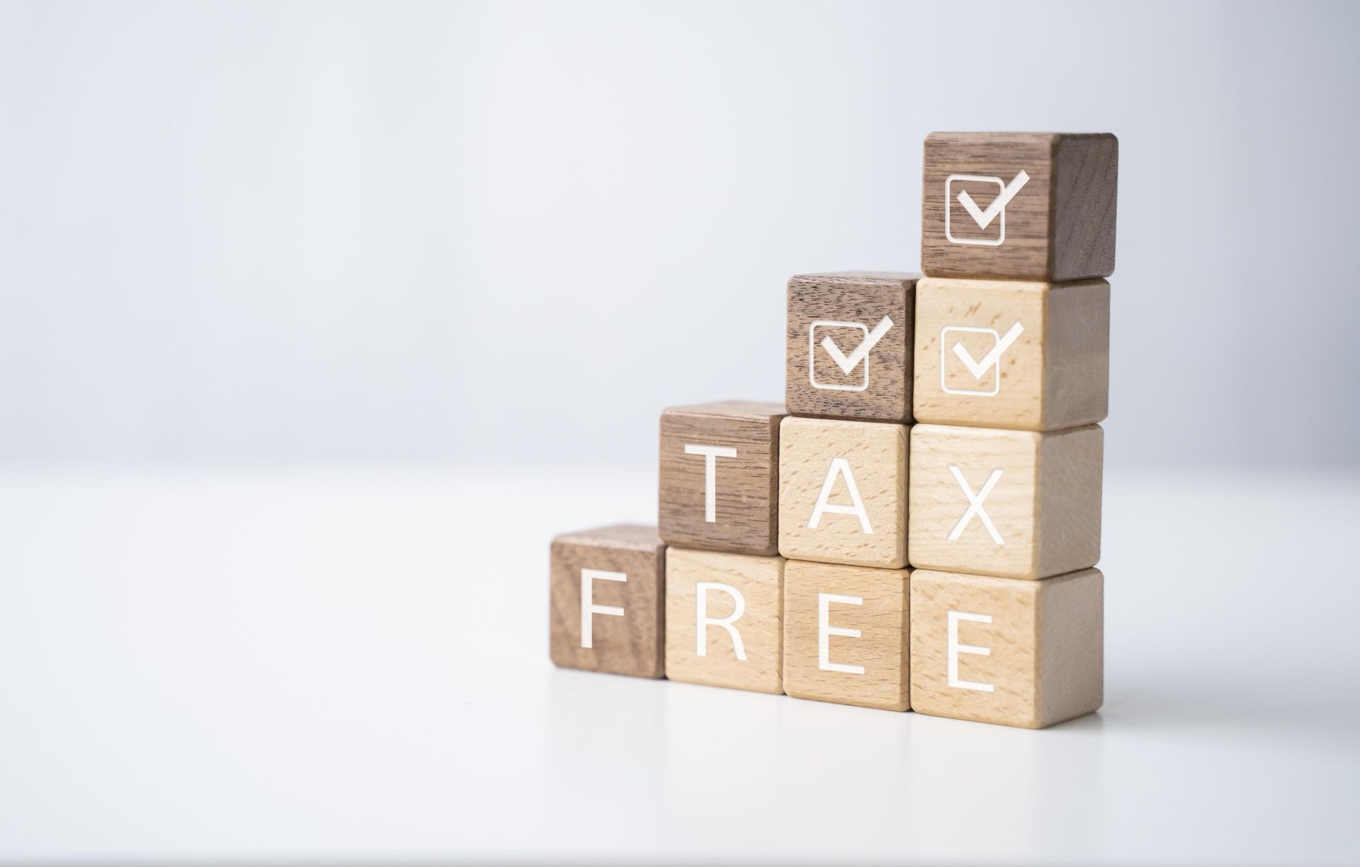 A stack of wooden blocks with the words tax free written on them.