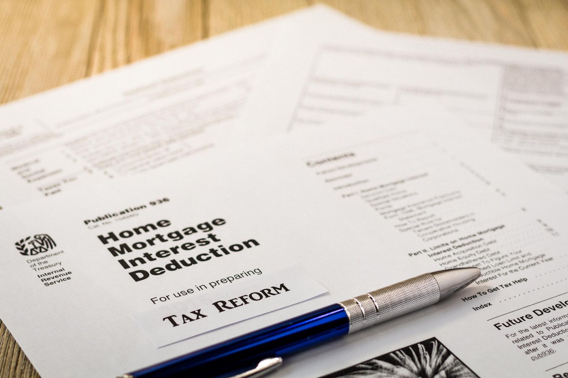 A pen is sitting on top of a piece of paper that says home mortgage interest deduction.