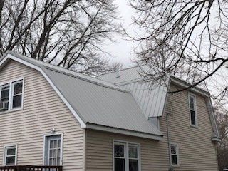 Gray House With Clean Roof And Sidings — Cedar Valley, IA — Raber Roofing Systems LLC.