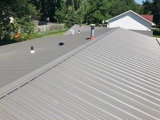 Metal Roof With Holes— Cedar Valley, IA — Raber Roofing Systems LLC.