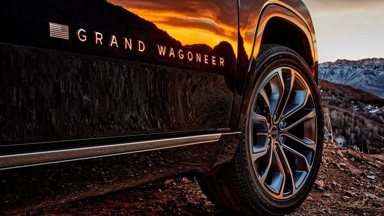 A jeep grand wagoneer is parked on a dirt road