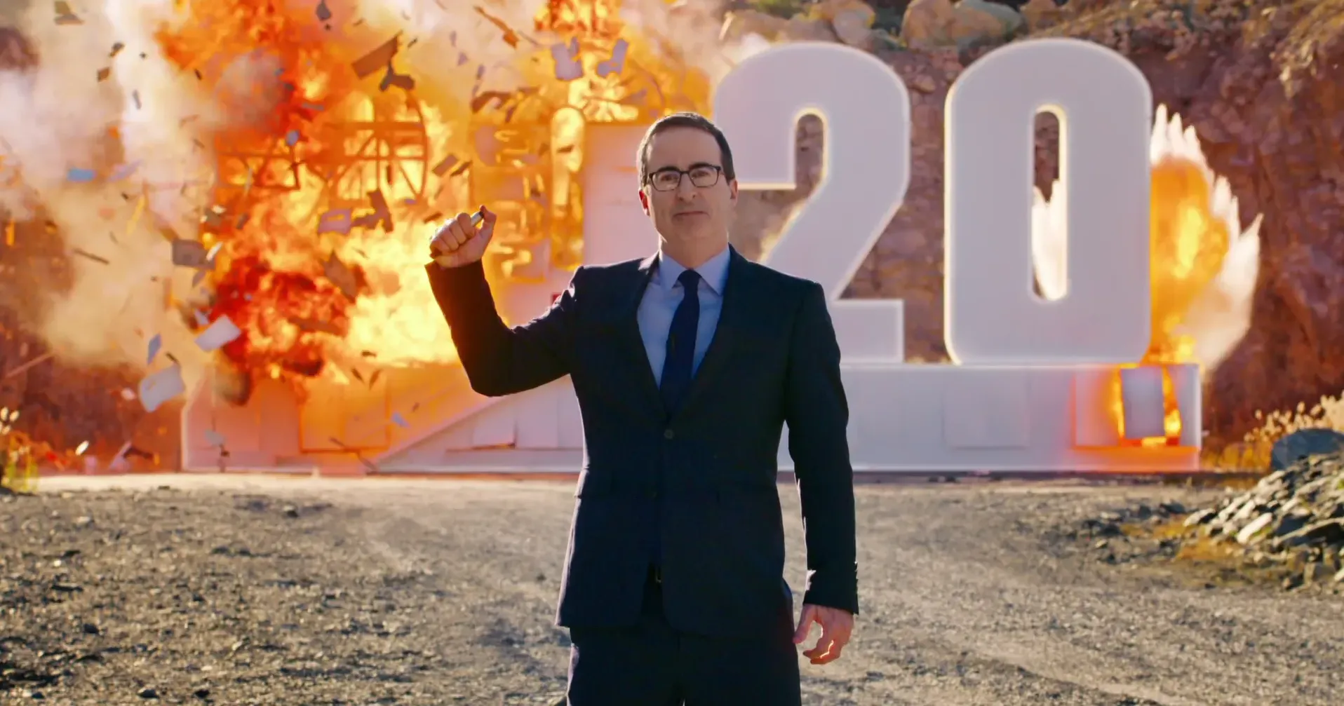 a man in a suit stands in front of a sign that says 2020