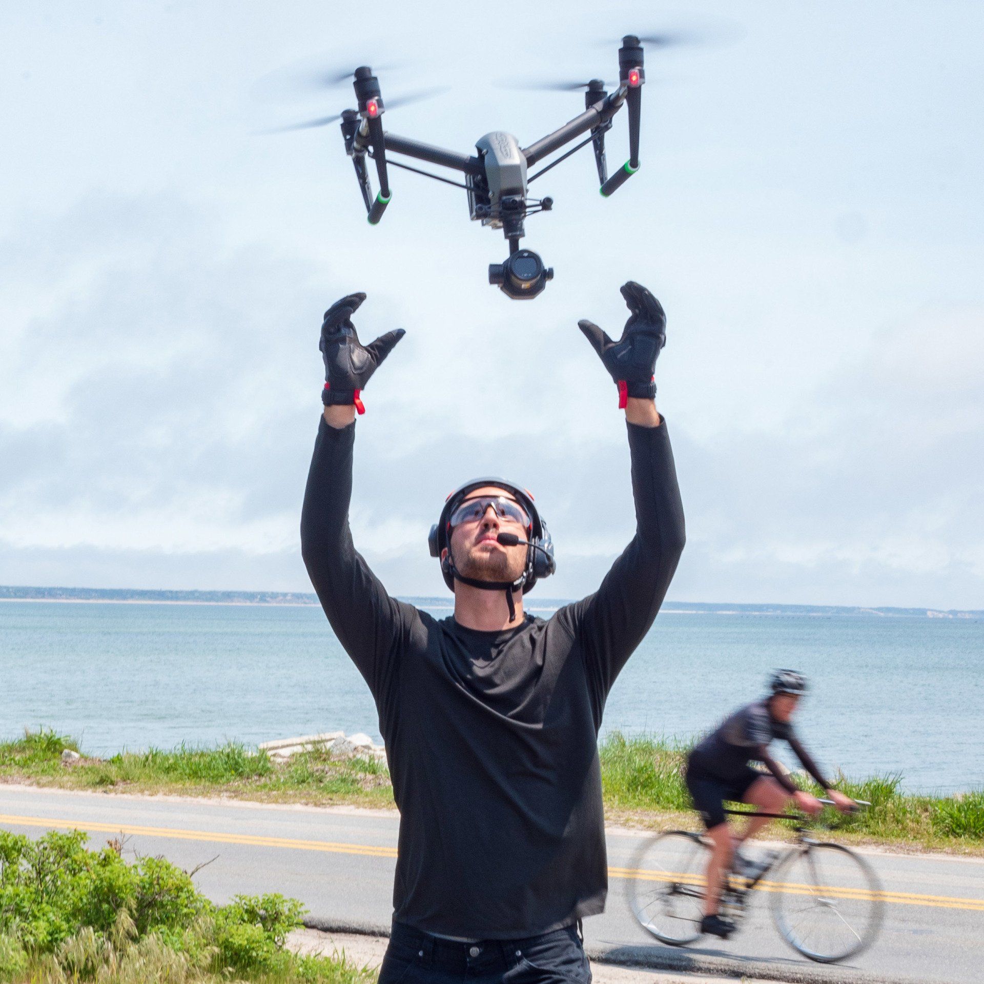 A man is throwing a drone in the air