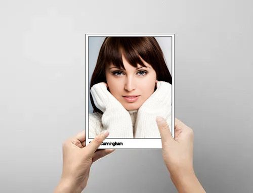 hand holding headshot of female model