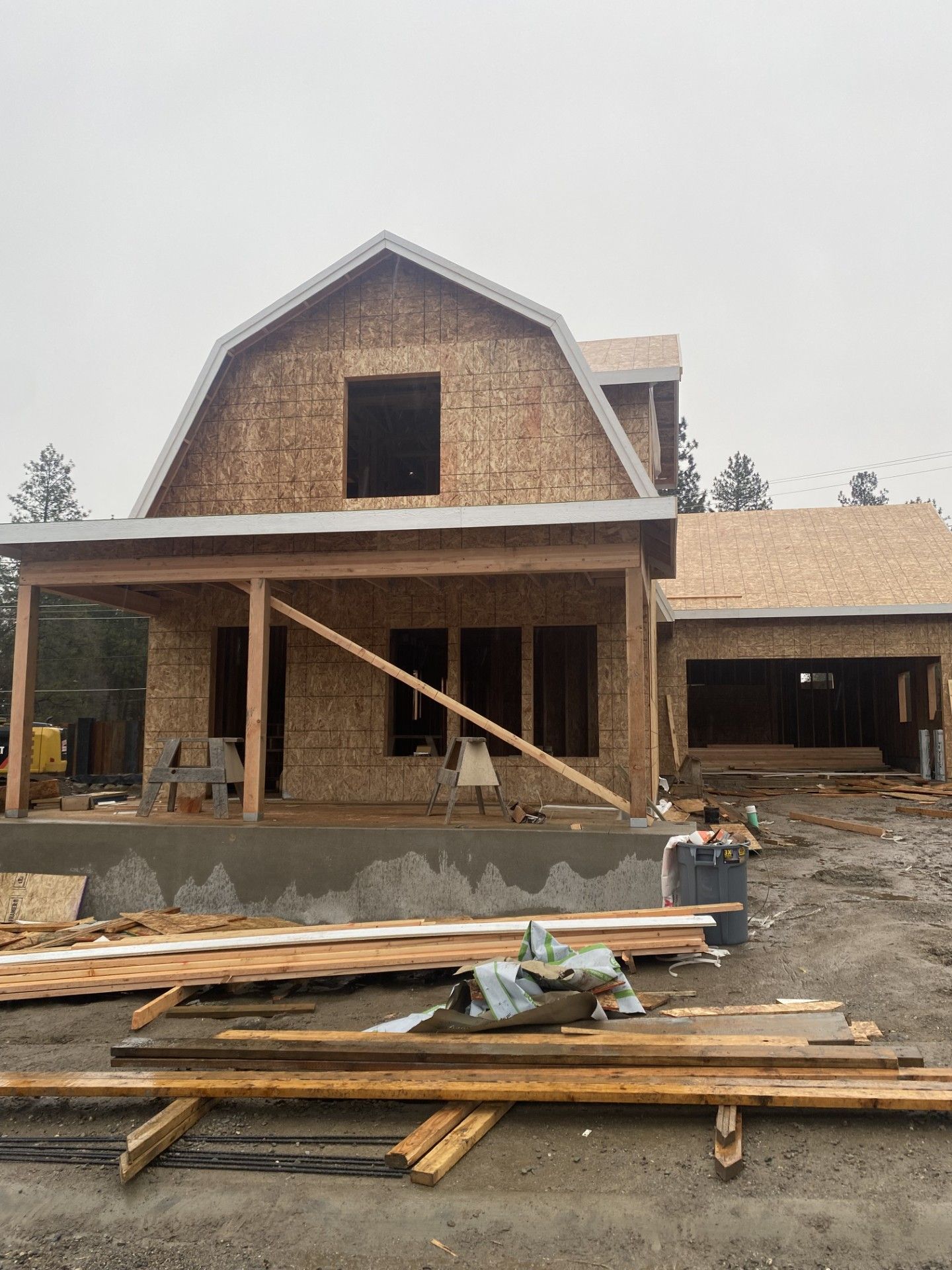 Worker in red shirt installing siding on a house exterior with a power drill Worker in red shirt installing siding on a house exterior with a power drill