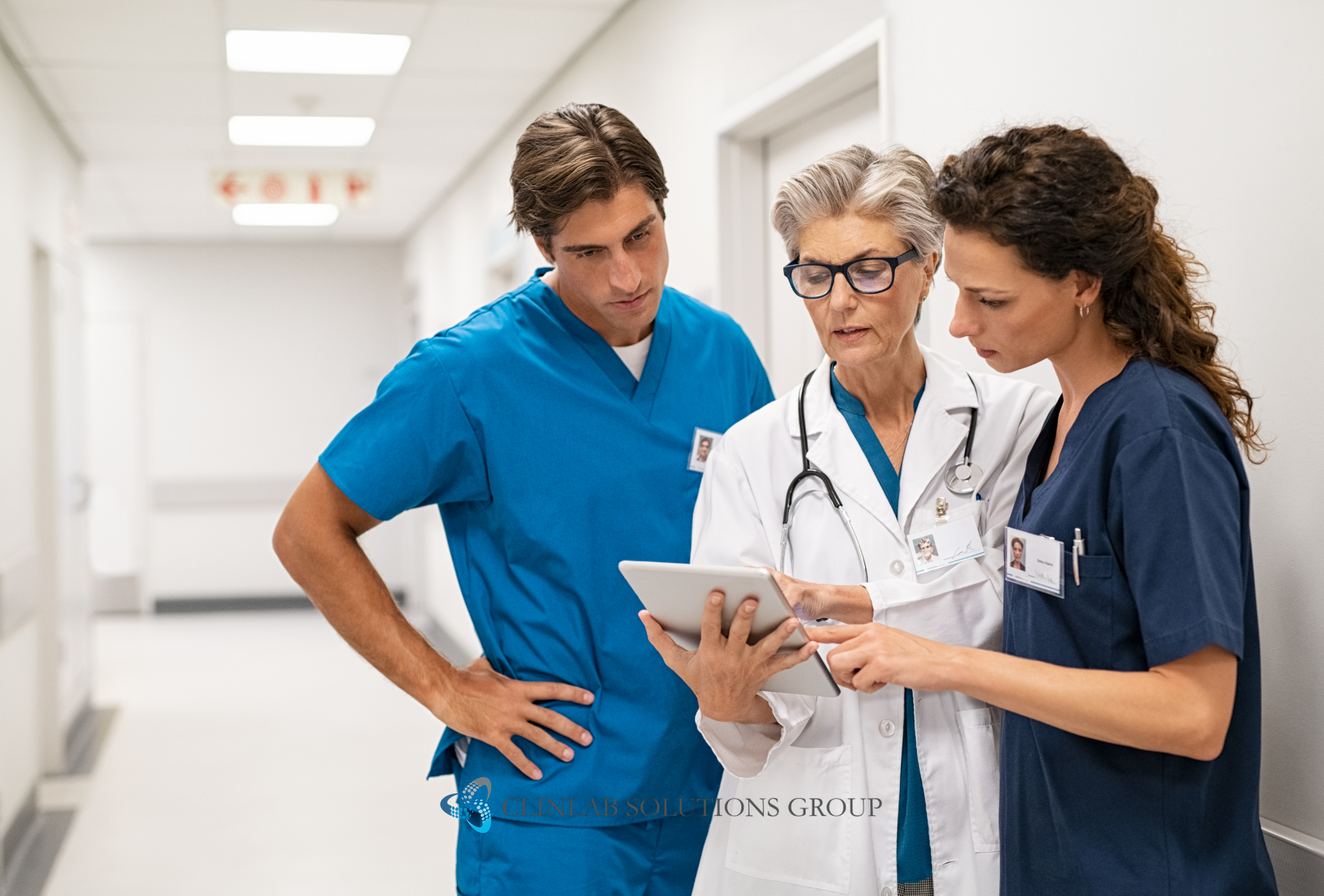 Medical staff reviewing a file together in a hospital setting.