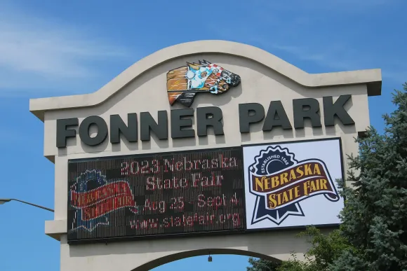 Sign for Fonner Park with Nebraska State Fair logo against blue sky
