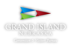 Grand Island Nebraska Convention & Visitors Bureau logo with multicolor geometric sail above text