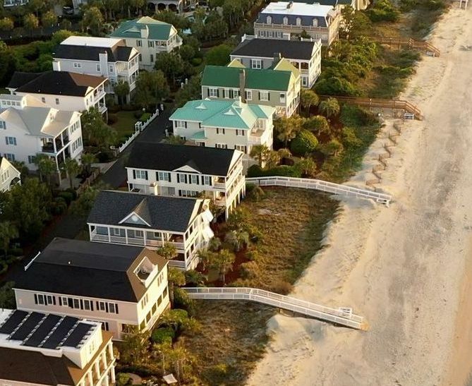 An aerial view of a beach with houses and trees