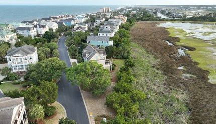 An aerial view of a residential area next to the ocean.