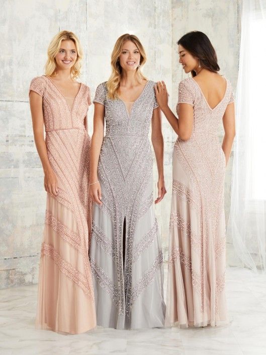 Three women in beaded formal dresses posing indoors; pink, silver, and blush tones.