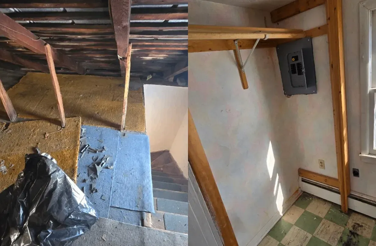 Damaged interior stairwell with exposed ceiling beams, debris, and a small windowed landing