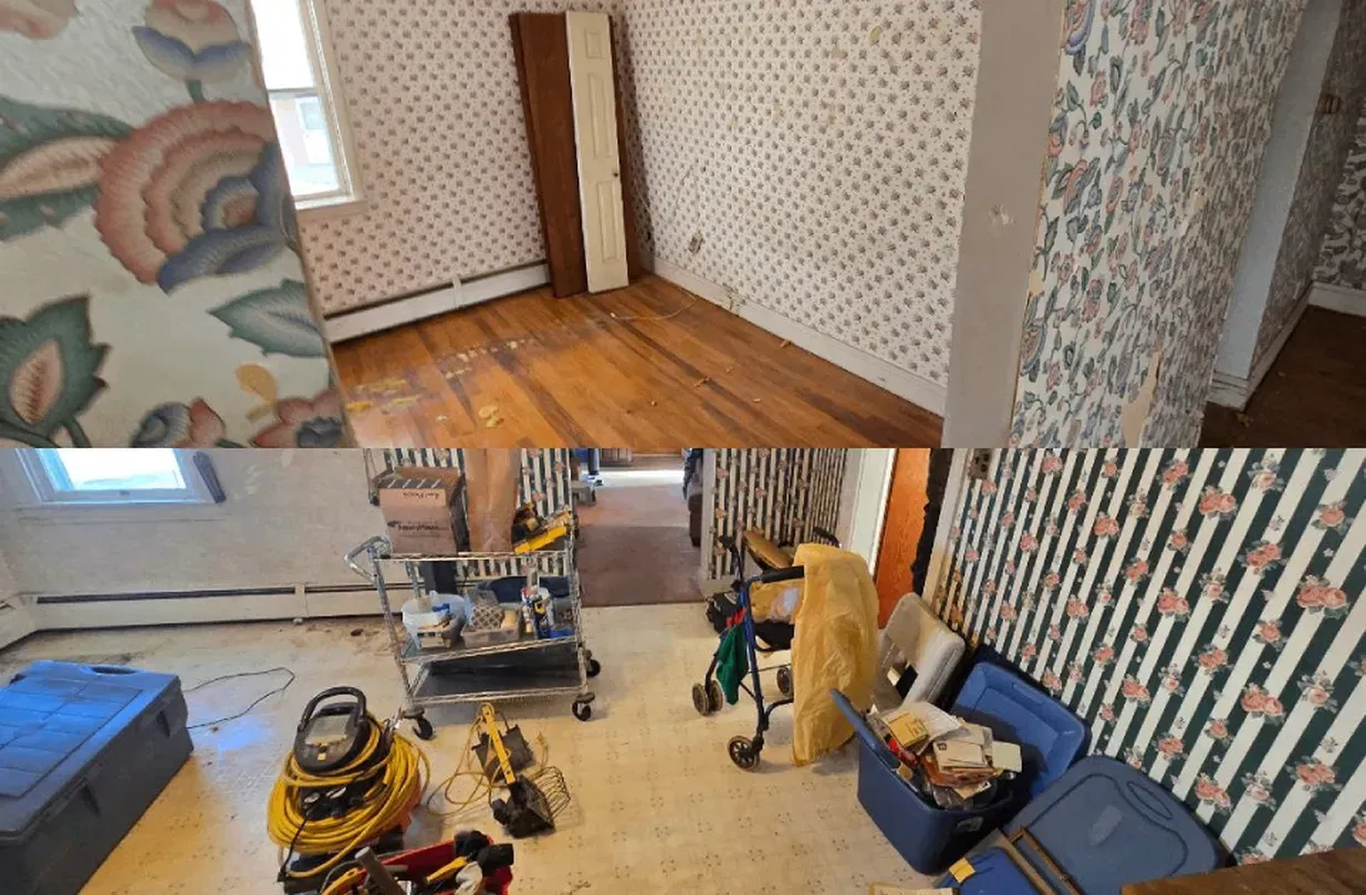 Partially renovated room with patterned wallpaper, wood floor, and scattered tools and supplies