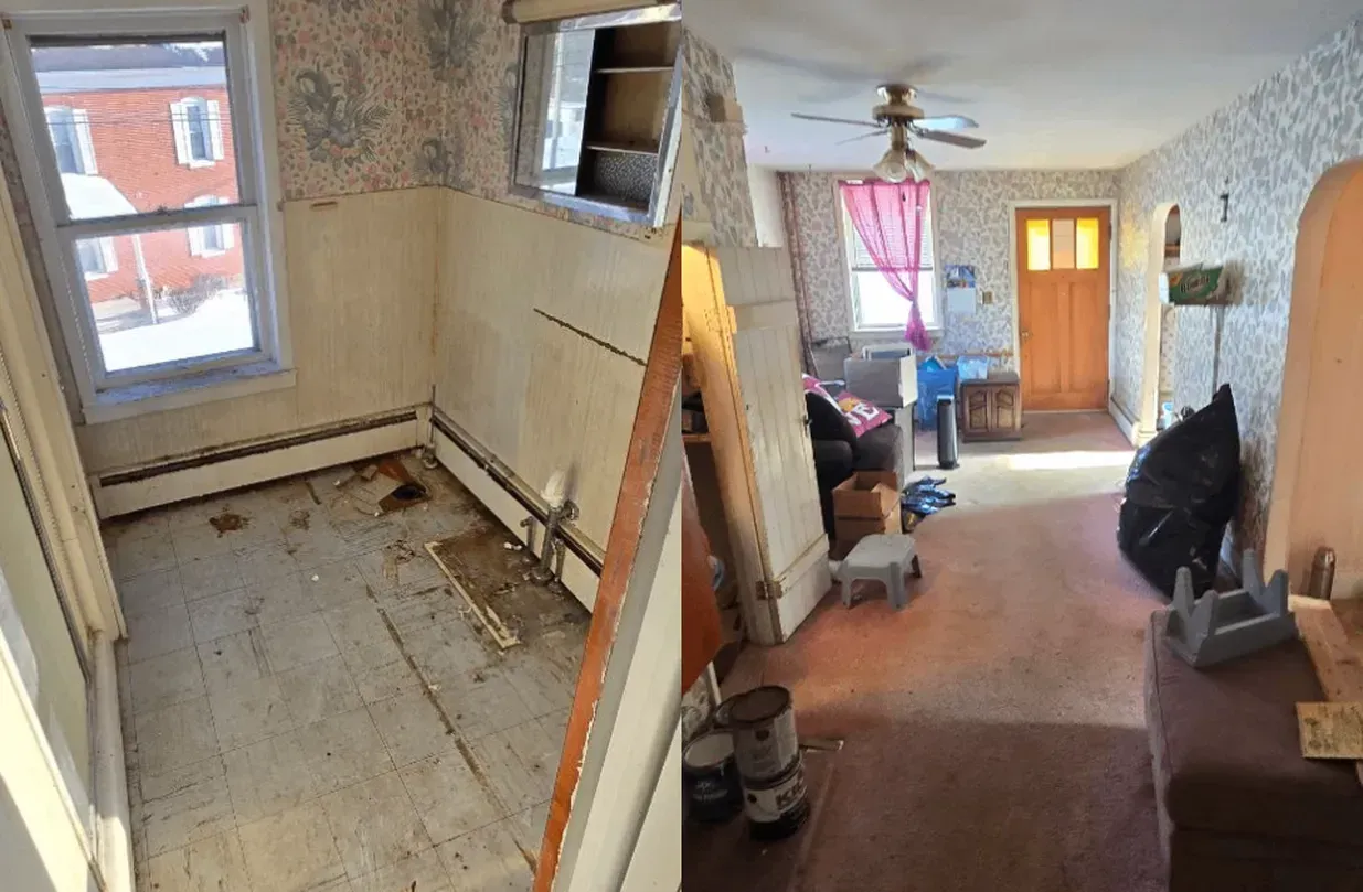 Renovation in progress in a narrow room and hallway with exposed walls, tools, and unfinished flooring.