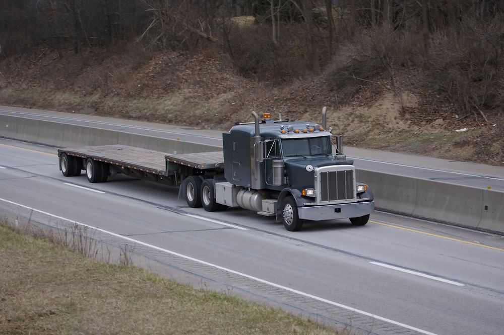 Semi-truck Hauling a Flatbed Trailer on a Highway — Barkly Hire in Dugald River, QLD