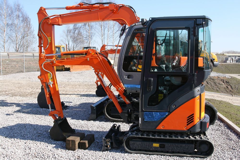 Orange Mini Excavator on Tracks Parked Outdoors in a Gravel Lot — Barkly Hire in Dugald River, QLD