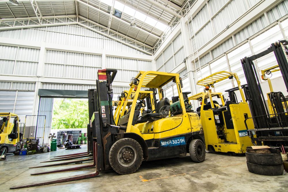 Yellow Forklifts Inside a Warehouse Service Bay — Barkly Hire in Camooweal, QLD