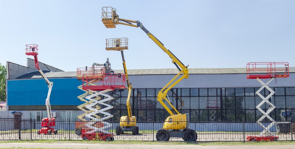 Group of Scissor Lifts Are Parked in Front of a Building — Barkly Hire in Ryan, QLD