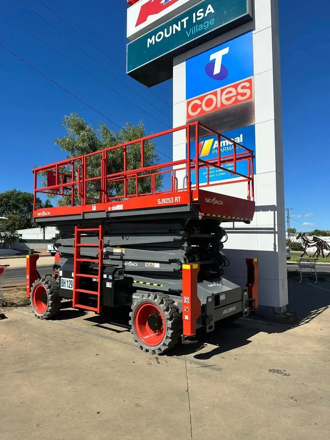 Row of Yellow Utility Trucks With Raised Boom Lifts — Barkly Hire in Richmond, QLD