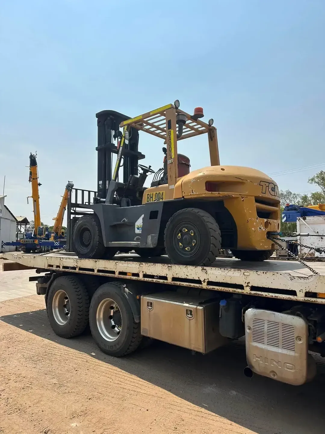 Yellow Industrial Forklift on a Flatbed Trailer — Barkly Hire in Camooweal, QLD