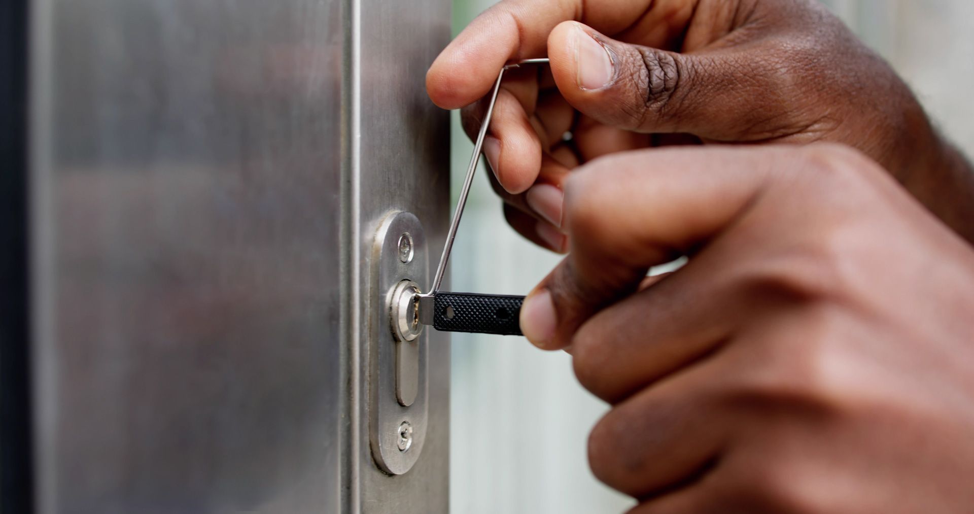 A person is using a key to open a door.