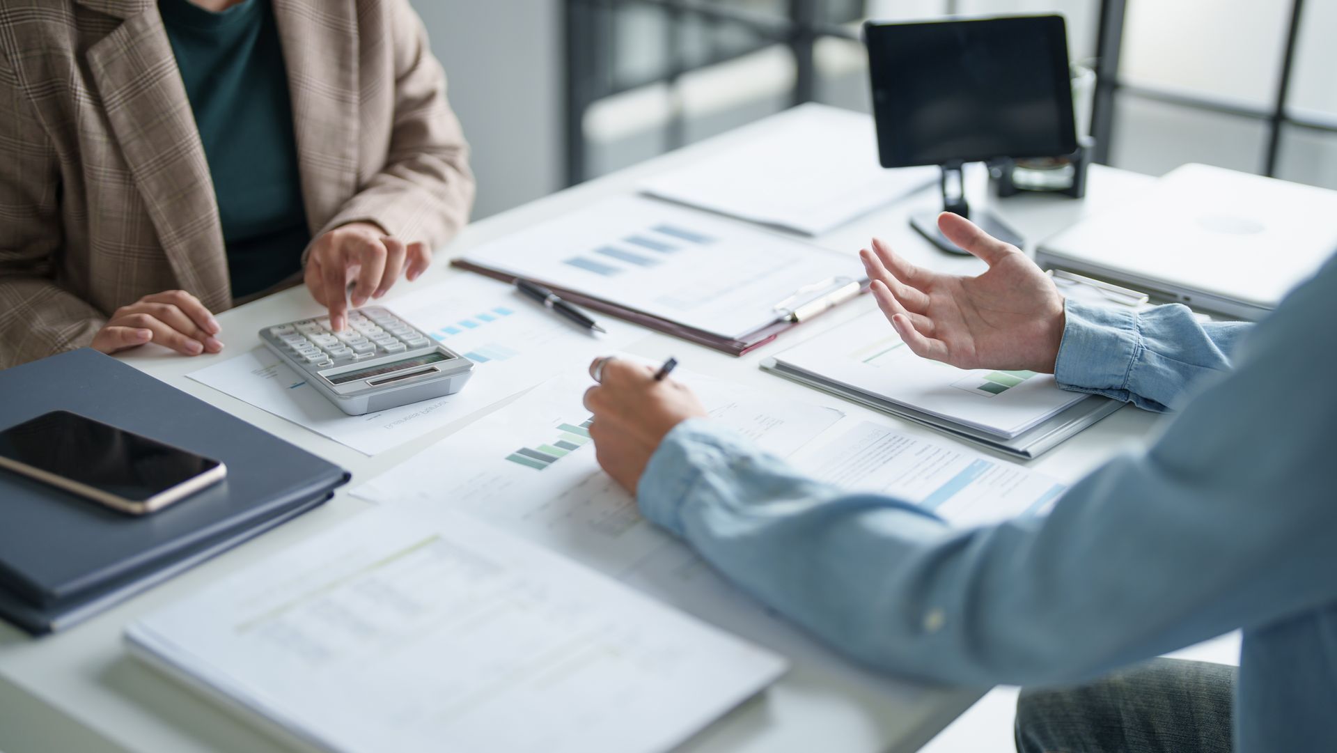 Lease management company employee reviewing a signed rental lease agreement