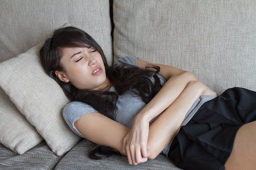 A young woman experiencing Laryngopharyngeal Reflux