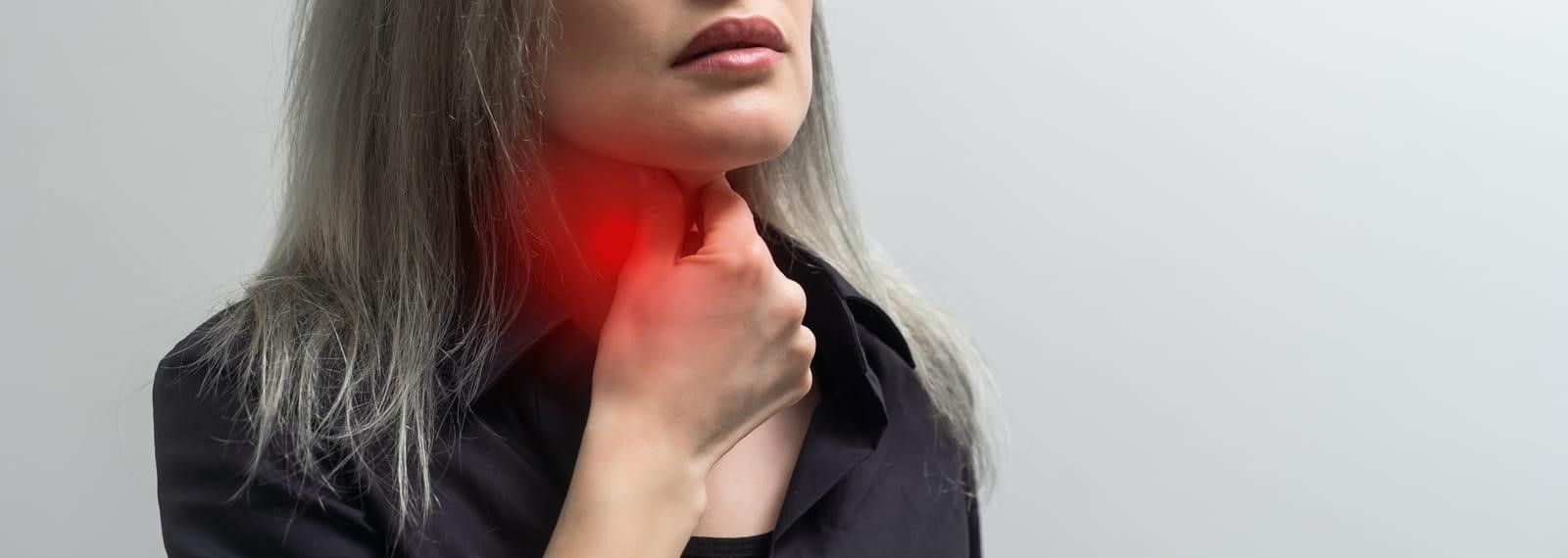 A female experiencing vocal problems.
