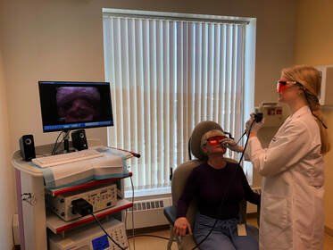 Dr. Burckardt using a laser on a patient