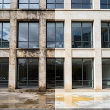 Before and after comparison of a building facade; dirty on the left, clean on the right.