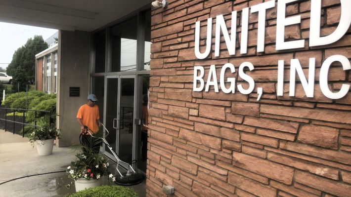 Entrance to UNITED BAGS, INC. with a person in an orange shirt walking by the doorway
