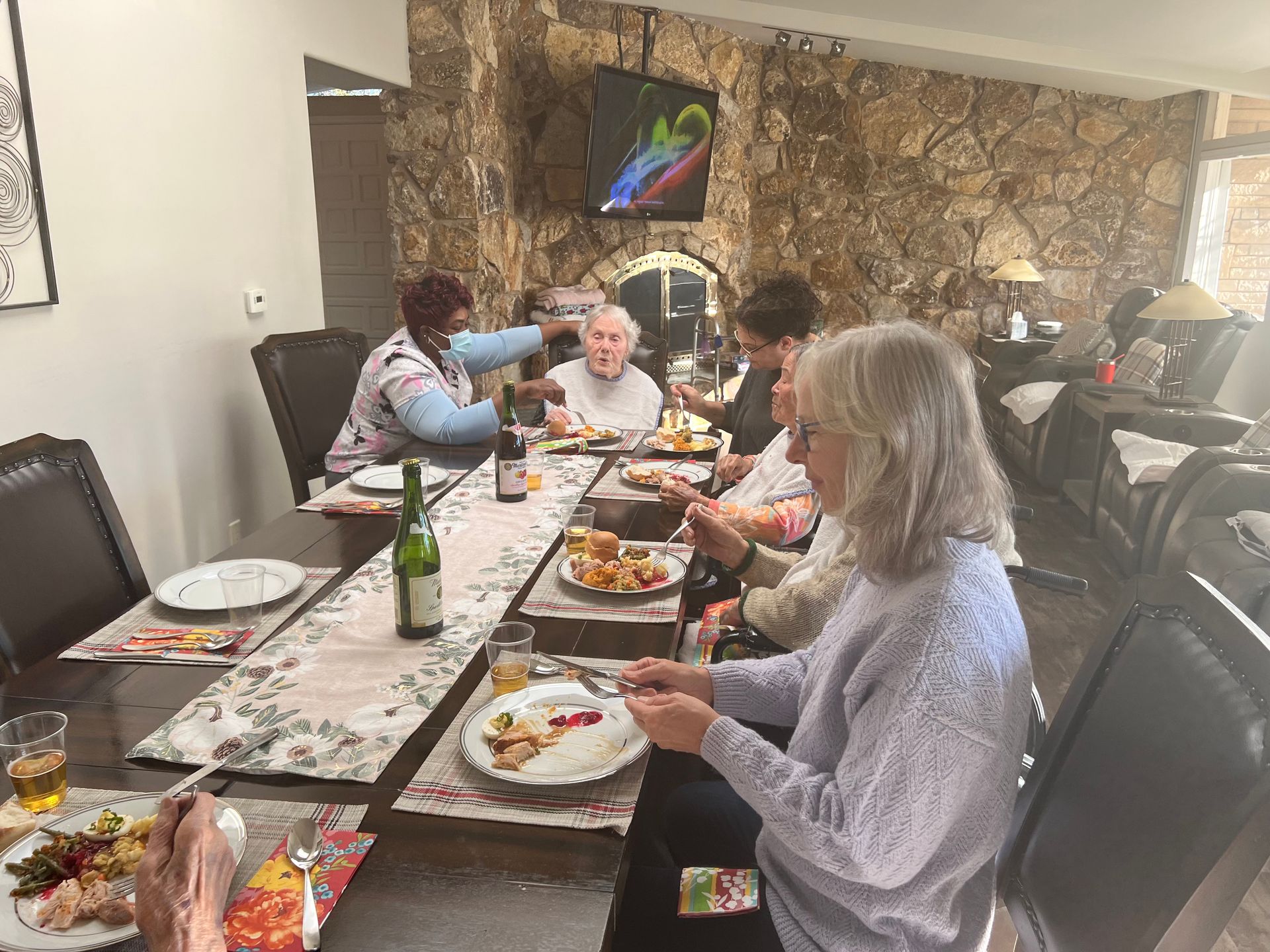 A group of people are sitting at a table eating food.