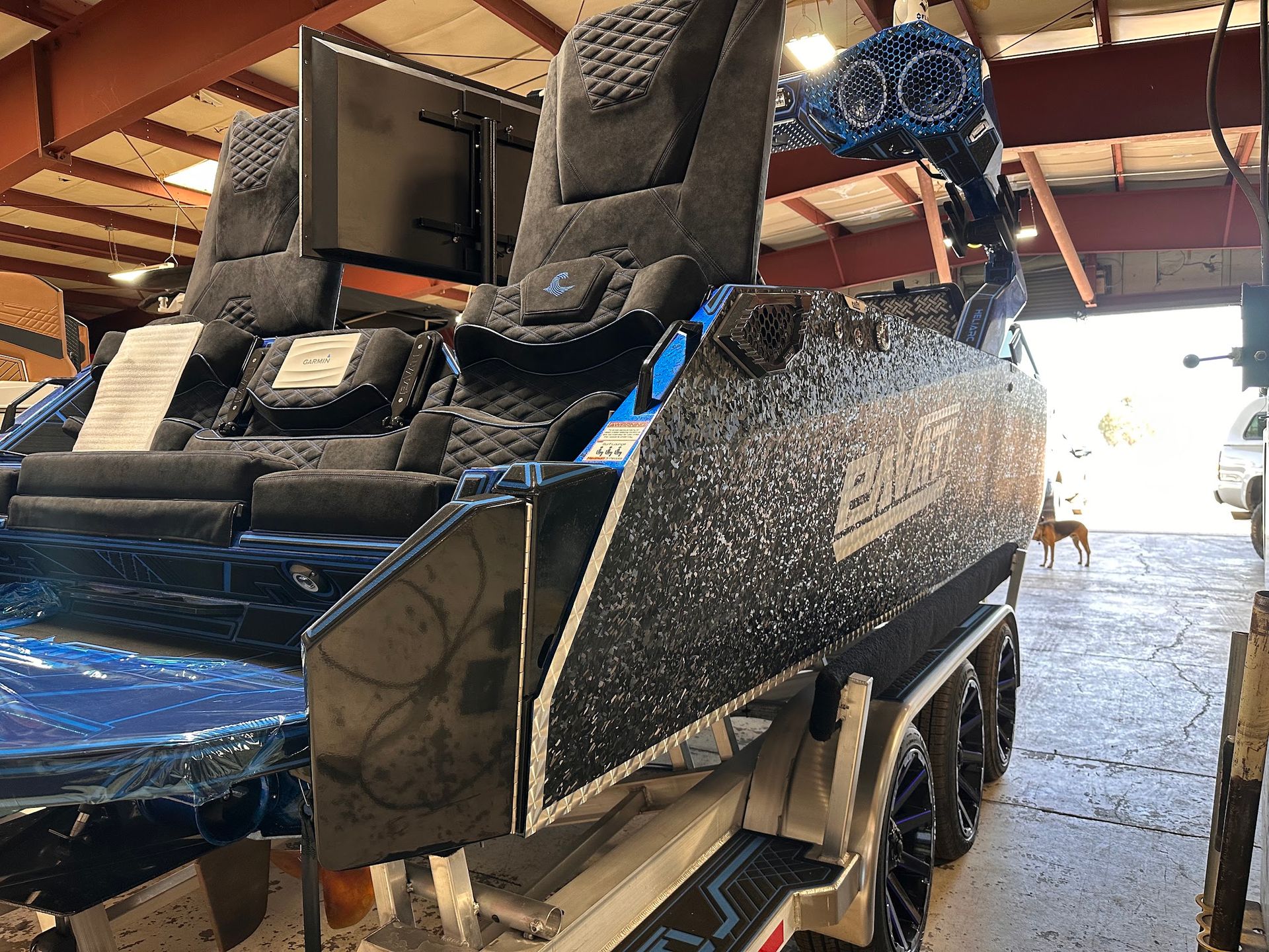 Large black power recliner with blue trim in a warehouse setting
