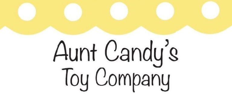 Logo for Aunt Candy's Toy Company with scalloped yellow border, white polka dots and text.